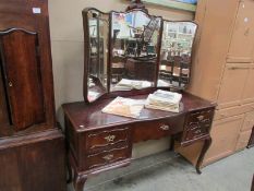 A dressing table with triple mirror