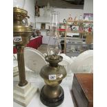 A brass oil lamp on pot base and with ch