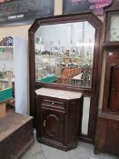 A large hall mirror with marble top cabi