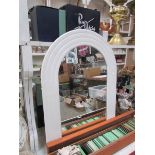 A white arched mirror