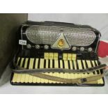 A 1930's accordian in case formerly owne