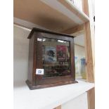 A glazed smokers cabinet