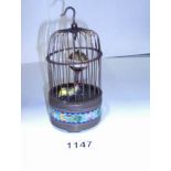 A cloissonne and brass birdcage automata