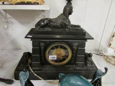 A Victorian black marble mantel clock su
