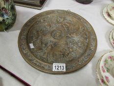 A cast brass plate decorated with animal