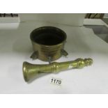 An early 19th century heavy brass pestle