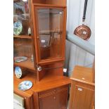 A teak corner cabinet by Morris of Glasg