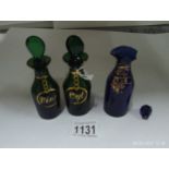 A pair of green and gilt oil bottles and