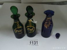 A pair of green and gilt oil bottles and