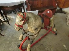 A metal rocking horse in need of restora