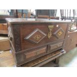 An oak chest with brass decoration