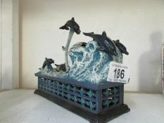 A cast iron mechanical dolphin money box