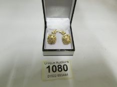 A pair of ear pendants set with diamonds
