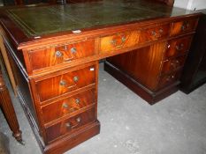 A mahogany double pedestal desk with gre