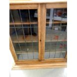 An oak lead glazed book case top and a b