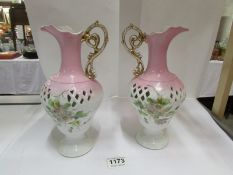 A pair of hand decorated ewers