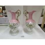 A pair of hand decorated ewers