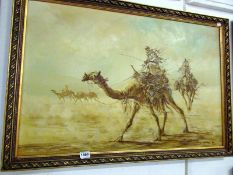 An oil on canvas of camels in the desert