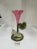 A cranberry glass spill vase surmounted