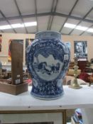 A large blue and white Oriental vase