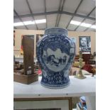 A large blue and white Oriental vase