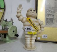 A waving Michelin man money bank