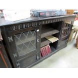 An oak book case with leaded glazed door