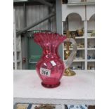 A cranberry glass jug