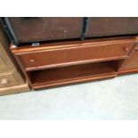 A teak side table with drawer