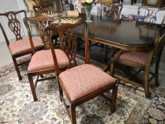 A mahogany extending dining table and 8