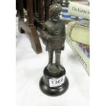 A patinated metal figure of an Indian of