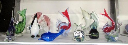 9 glass fish, a glass penguin and a glas