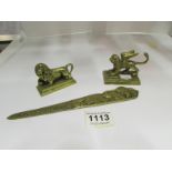 A brass letter opener, lion figure and d