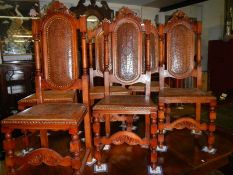 A set of 6 chairs with tooled leather seats and backs