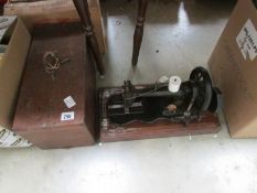 A cased hand sewing machine