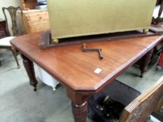 A Victorian oak wind out table with one