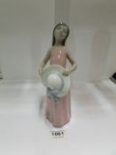 A Lladro girl with large hat