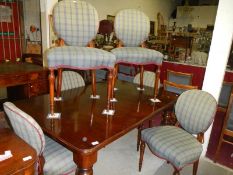 A mahogany extending dining table and 6
