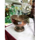 A copper bowl with George III coins on s