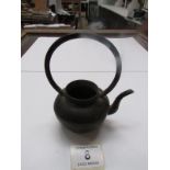 A small Oriental bronze kettle
