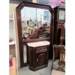 A mahogany marble top cabinet with large