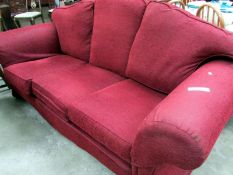 A red 3 seater sofa