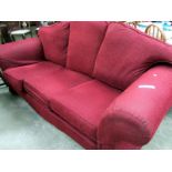 A red 3 seater sofa