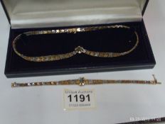 A silver necklet and bracelet