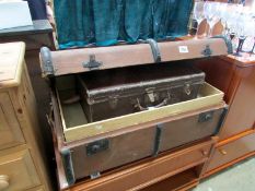 A vintage travel trunk and suitcase