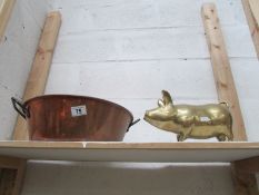 A copper jam pan and a large brass pig