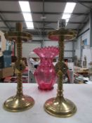 A pair of ecclesiastical brass candlesti