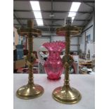 A pair of ecclesiastical brass candlesti