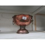 A copper punch bowl