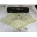A Japanese ivory and silk fan, the guard
